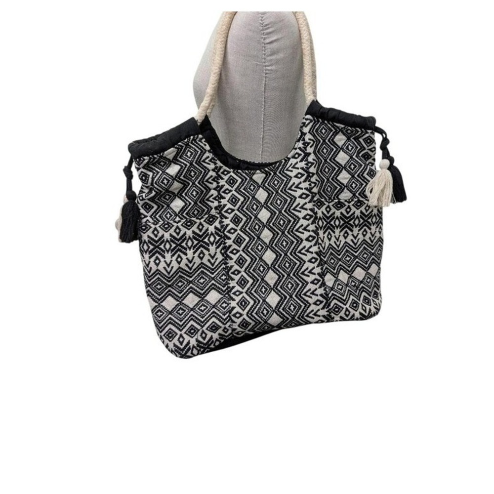 Black + white geometric patterned tote bag with tassels
